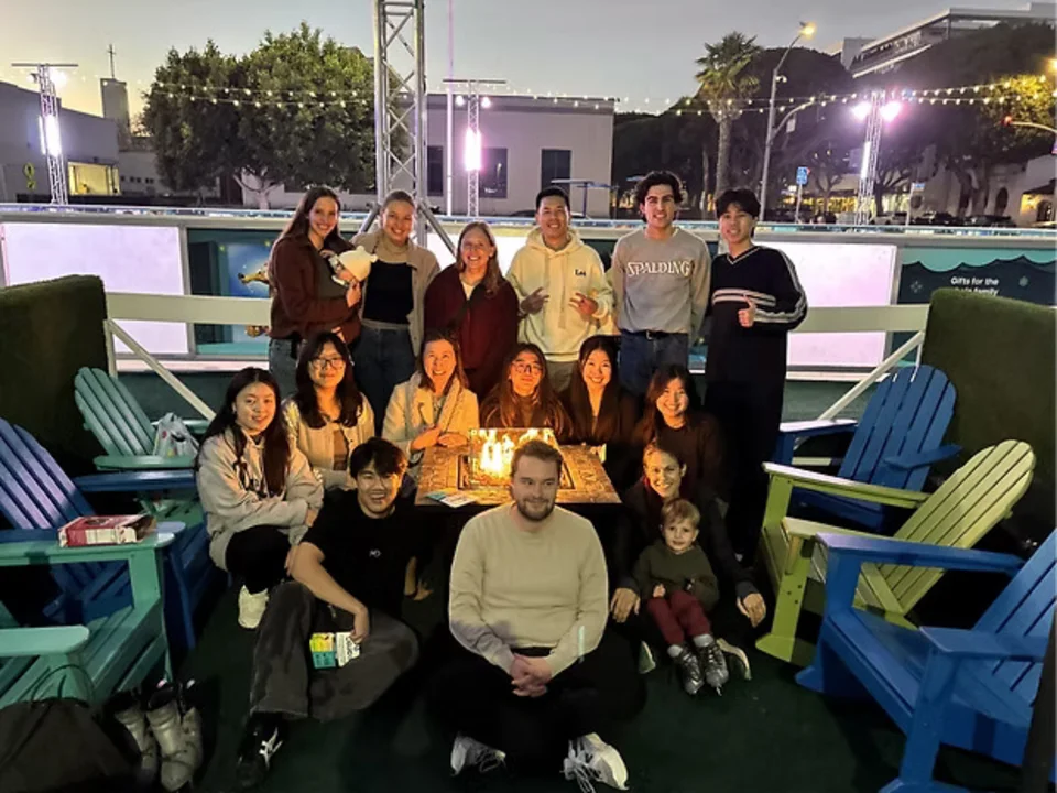 Group posing in front of an ice skating rink
