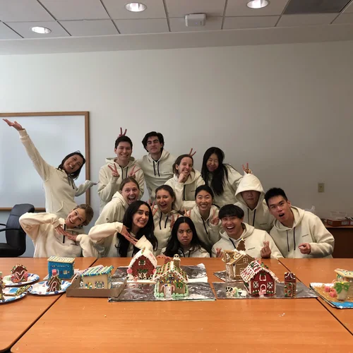 Lab posing behind gingerbread houses