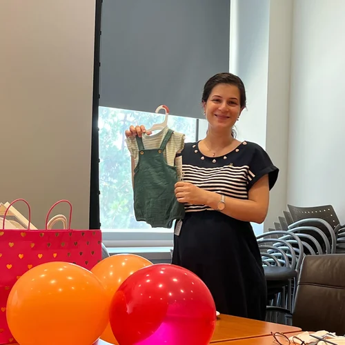 Lab member holding baby clothes
